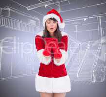 Composite image of sexy santa girl blowing over hands