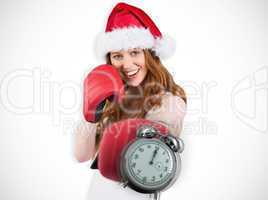 Composite image of festive redhead punching with boxing gloves