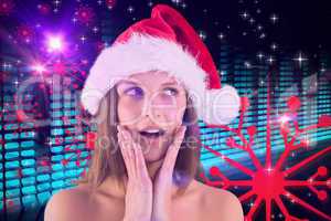 Composite image of festive brunette looking surprised with hands