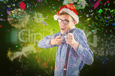 Composite image of geeky hipster wearing santa hat