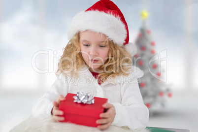 Composite image of cute girl with gift