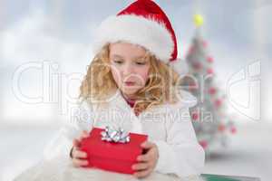 Composite image of cute girl with gift