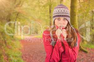 Composite image of cold redhead wearing coat and hat