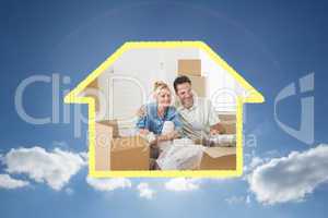 Composite image of smiling couple unpacking boxes in a new house