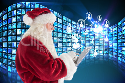 Composite image of santa uses a tablet pc