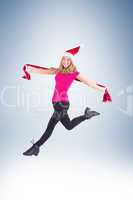 Festive blonde skipping and smiling at camera