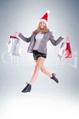 Stylish blonde walking with shopping bags