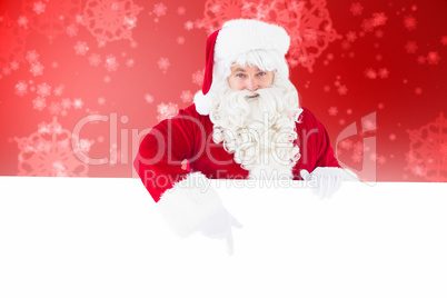 Composite image of joyful santa claus presenting sign