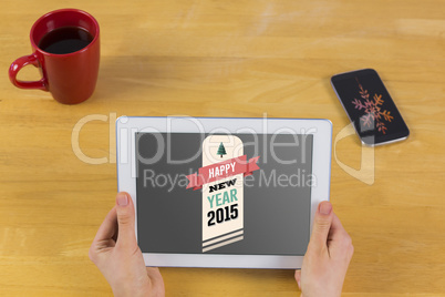 Composite image of businesswoman using tablet at desk