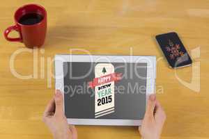 Composite image of businesswoman using tablet at desk