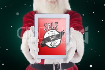 Composite image of santa presents a tablet pc