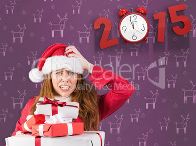 Composite image of festive stressed redhead holding gifts