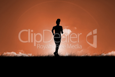 Composite image of fit brunette jogging away from camera