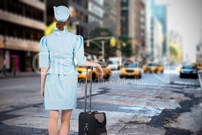 Composite image of pretty air hostess leaning on suitcase