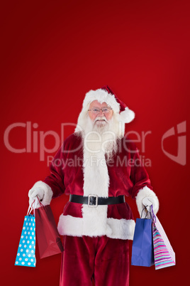 Composite image of santa carries some christmas bags