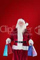 Composite image of santa carries some christmas bags