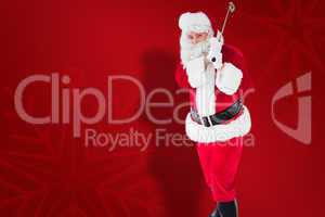 Composite image of cheerful santa claus playing golf