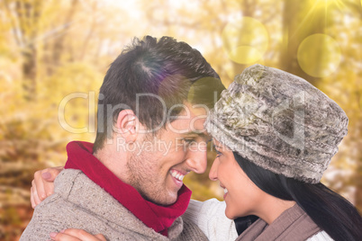 Composite image of young couple smiling and hugging