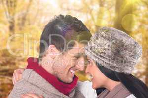 Composite image of young couple smiling and hugging
