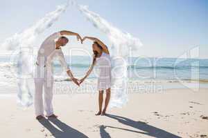 Composite image of cute couple forming heart shape with arms