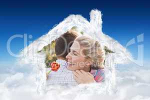 Composite image of smiling young couple embracing in park