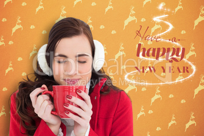 Composite image of woman in winter clothes enjoying a hot drink