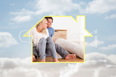 Composite image of lovely couple sitting on the floor