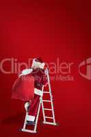 Composite image of santa steps up a ladder