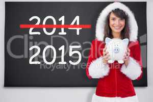 Composite image of smiling brunette in santa claus holding a pig
