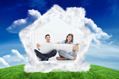 Composite image of man and his wife looking at their house plans