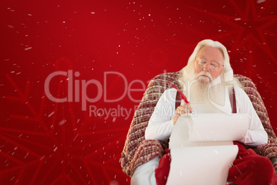 Composite image of father christmas writing list with a quill