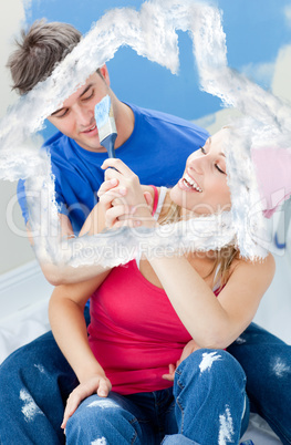 Composite image of happy couple painting a room
