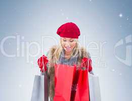 Blonde in winter clothes looking in shopping bags