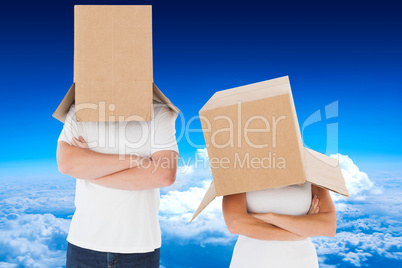 Composite image of mature couple wearing boxes over their heads