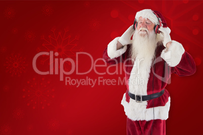 Composite image of santa claus enjoys some music