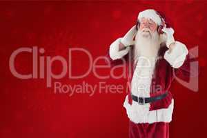 Composite image of santa claus enjoys some music