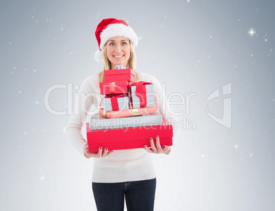 Festive blonde holding pile of gifts