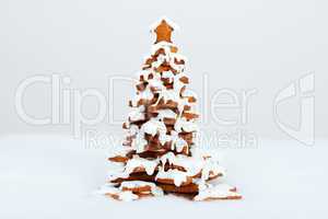 The hand-made eatable gingerbread New Year Tree with snow decora