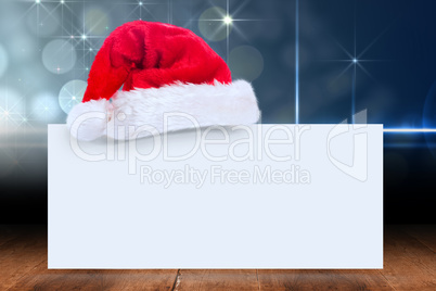 Composite image of santa hat on poster