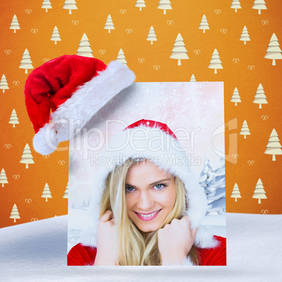 Composite image of pretty girl smiling in santa outfit