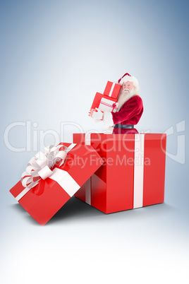 Santa standing in large gift