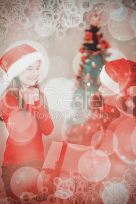 Composite image of mother giving her daughter a christmas presen