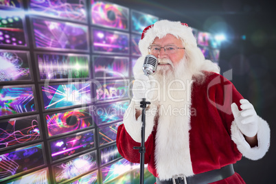 Composite image of santa claus is singing christmas songs