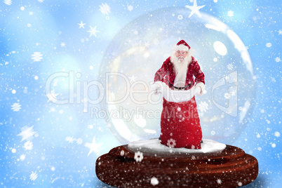 Composite image of santa holding open sack snow globe