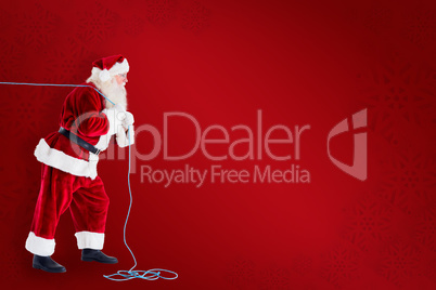 Composite image of santa pushes a shopping cart