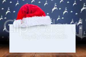 Composite image of santa hat on poster