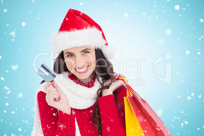 Composite image of excited brunette holding shopping bags and cr