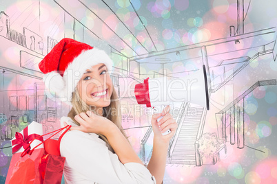 Composite image of festive blonde holding megaphone and bags