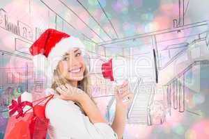 Composite image of festive blonde holding megaphone and bags