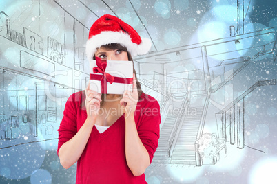 Composite image of festive young woman holding a gift